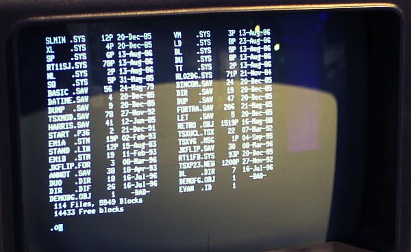 Up-close photograph of an old PC terminal listing the filesystem